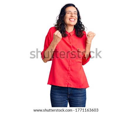 Young beautiful hispanic woman wearing casual clothes excited for success with arms raised and eyes closed celebrating victory smiling. winner concept. 