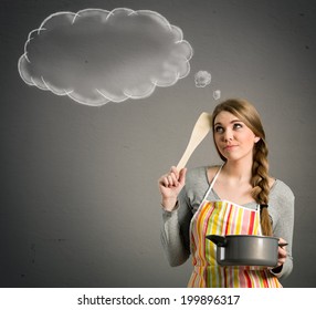 young beautiful housewife with empty think clouds, concept - What to cook today?