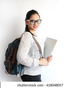 A Young Beautiful Indian College Student Holding Laptop On Isolated White Background