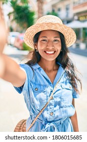 Young Beautiful Indian Woman Wearing Summer Hat Smiling Happy Making Selfie By The Camera At The City.