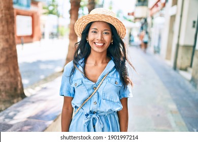 Young Beautiful Indian Woman Wearing Summer Hat Smiling Happy Walking At The City.