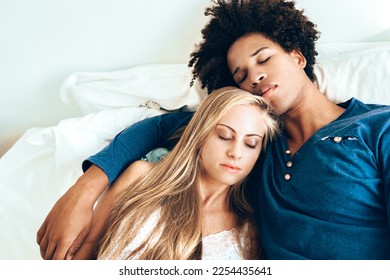 Young beautiful interracial couple in bed sleeping - Powered by Shutterstock