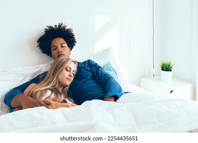 Young beautiful interracial couple in bed sleeping - Shutterstock ID 2254435651