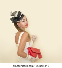 Young Beautiful Lady Dressed In A Proper Outfit For Horse Racing In White Dress With Hat And Gloves With Red Lipstick, Fashion On The Field