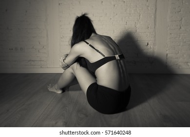 Young Beautiful Latin Woman Or Teen Girl Sitting Sad And Alone In Edgy Darkness Feeling Depressed And Desperate In Mental And Nutrition Disorder Concept Anorexia And Bulimia