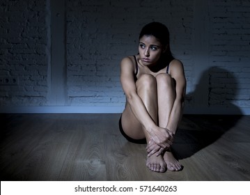 Young Beautiful Latin Woman Or Teen Girl Sitting Sad And Alone In Edgy Darkness Feeling Depressed And Desperate In Mental And Nutrition Disorder Concept Anorexia And Bulimia