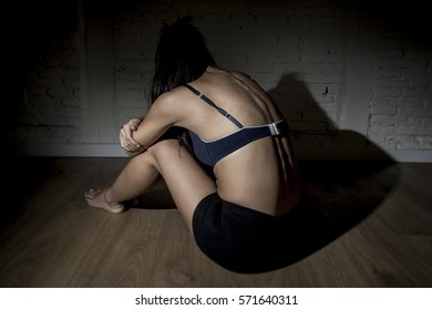 Young Beautiful Latin Woman Or Teen Girl Sitting Sad And Alone In Edgy Darkness Feeling Depressed And Desperate In Mental And Nutrition Disorder Concept Anorexia And Bulimia