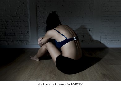 Young Beautiful Latin Woman Or Teen Girl Sitting Sad And Alone In Edgy Darkness Feeling Depressed And Desperate In Mental And Nutrition Disorder Concept Anorexia And Bulimia