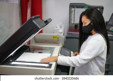 Young Beautiful Long Haired Woman With Face Mask Making Copies With Copy Machine