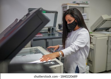 Young Beautiful Long Haired Woman With Face Mask Making Copies With Copy Machine