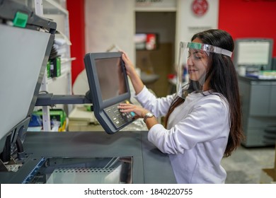 Young Beautiful Long Haired Woman With Face Shield Making Copies With Copy Machine