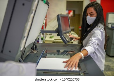 Young Beautiful Long Haired Woman With Face Mask Making Copies With Copy Machine