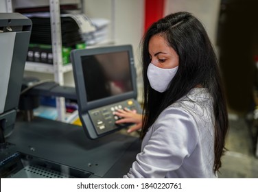 Young Beautiful Long Haired Woman With Face Mask Making Copies With Copy Machine