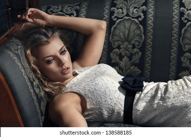 Young Beautiful Luxurious Woman Lying On A Vintage Couch