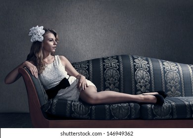 Young Beautiful Luxurious Woman Lying On A Vintage Couch