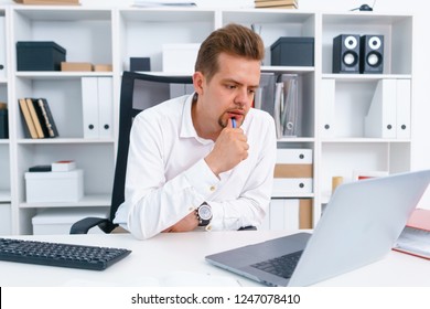 young beautiful man work on computer sit at table in office smile enjoy her work concept