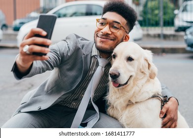 Young beautiful mixed race business man taking selfie with his dog - best friends, bonding, sociable concept - Shutterstock ID 1681411777