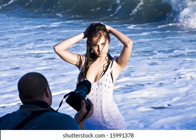 Young beautiful model posing wet on the beach