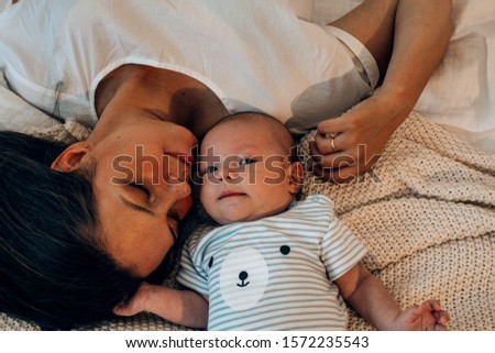 Similar – Mother hugging her newborn baby girl