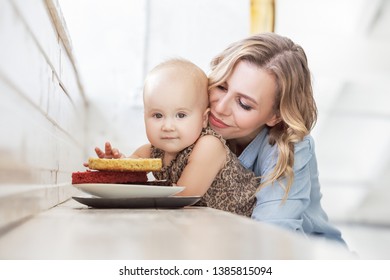 Young Beautiful Mother Feeds Her Little Baby With Harmful Sweet Food. The Concept Of Malnutrition Children And Excess Of Desserts For Kids