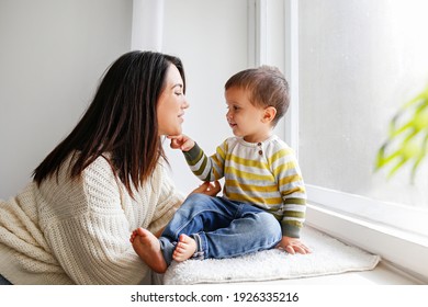 Young Beautiful Mother With Her Two Year Old Son At Home. Woman Spending Quality Time With Her Toddler Child. Close Up, Copy Space, Background