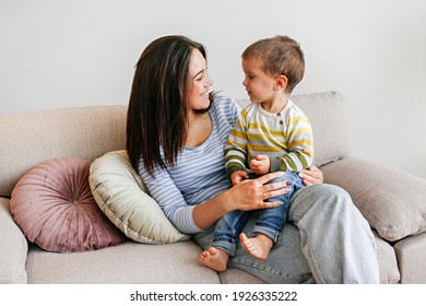 Young Beautiful Mother With Her Two Year Old Son At Home. Woman Spending Quality Time With Her Toddler Child. Close Up, Copy Space, Background