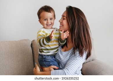 Young Beautiful Mother With Her Two Year Old Son At Home. Woman Spending Quality Time With Her Toddler Child. Close Up, Copy Space, Background