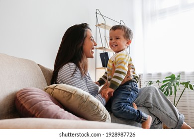 Young Beautiful Mother With Her Two Year Old Son At Home. Woman Spending Quality Time With Her Toddler Child. Close Up, Copy Space, Background