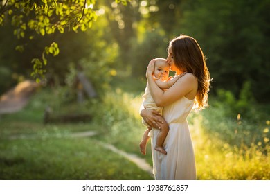 Young beautiful mother plays with her child outdoor. - Powered by Shutterstock