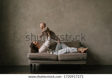 Similar – Foto Bild Kaukasische Mutter und Kleinkind Sohn auf der Couch sitzend mit Tablette