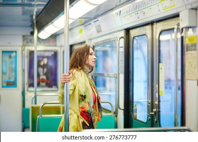 Young Beautiful Parisian Woman Travelling In A Subway Train, Standing Near The Window