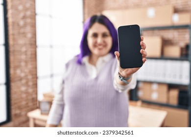 Young beautiful plus size woman ecommerce business worker showing smartphone screen at office - Powered by Shutterstock