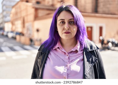 Young beautiful plus size woman standing with serious expression at street - Powered by Shutterstock