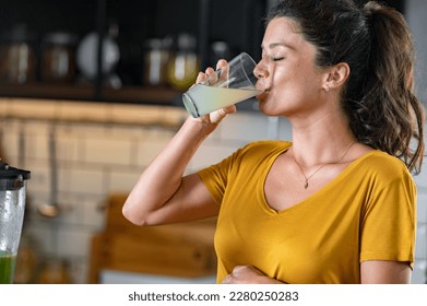 Young beautiful pregnant lady making various fruit smoothies in the home kitchen. Fresh colorful healthy fruit juice. Healthy lifestyle in pregnancy. Smoothies for woman expecting baby. - Shutterstock ID 2280250283