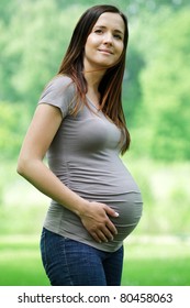 Young beautiful pregnant woman with long dark hair.
