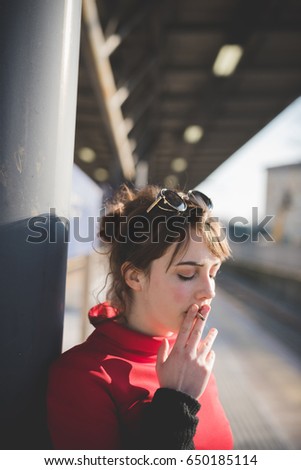 young beautiful red dressed vintage hipster woman in street town