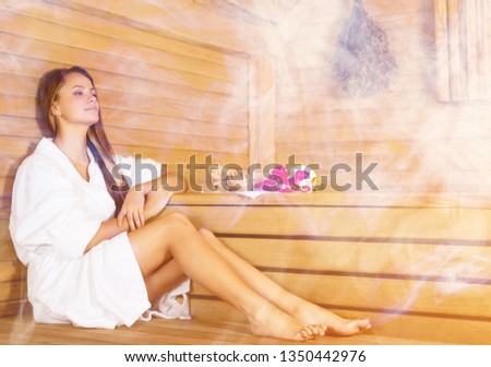 Young beautiful relaxed woman in sauna