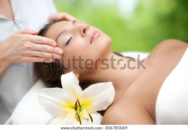 Young Beautiful Relaxing Woman Having A Facial Massage