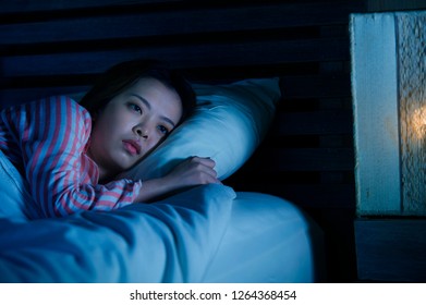 Young Beautiful Sad And Depressed Asian Chinese Girl Lying On Bed Late Night Awake Looking Thoughtful Suffering Insomnia Sleeping Disorder Feeling Tired And Worried In Woman Depression Concept
