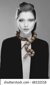 Young, beautiful, sensual woman with snake around her neck; a lot of copyspace available