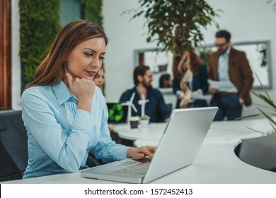 Young Beautiful Serious Pensive Worried Businesswoman Is Analyzing Bussiness Plans And Working On Laptop In The Office.