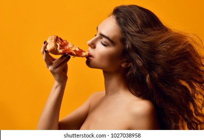 Young Beautiful Sexy Woman Eat Hot Pepperoni Pizza Slice On Yellow Background