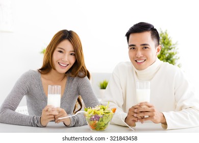 Young Beautiful Smiling Couple Drinking Milk