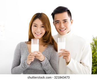 Young Beautiful Smiling Couple Drinking Milk