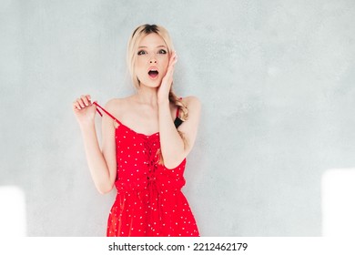 Young Beautiful Smiling Female In Trendy Summer Red Dress. Sexy Carefree Blond  Woman Posing Near Wall In Studio. Positive Model Having Fun. Cheerful And Happy. At Sunny Day. Shocked, Surprised