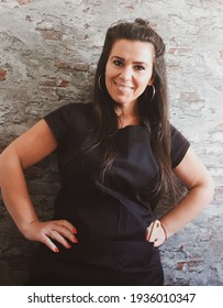 Young   Beautiful Smiling Italian  Woman At  Home  Cooking  At The Kitchen