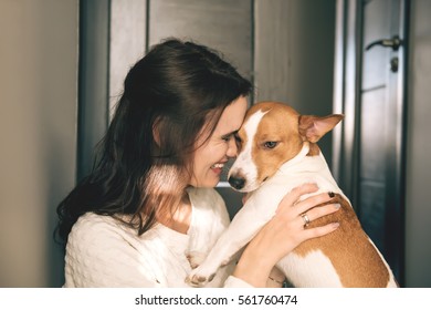 Young Beautiful Smiling Woman Hugging Her Pet - Dog At Home. Close Up Portrait.