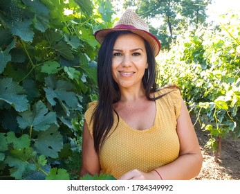 Young Beautiful  Smiling Woman  In Wineyard.Wine Eco Tourism