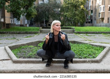 Young Beautiful Strong Independent Rebel Blonde Woman Punk Music And Style Fan Posing. Confident Punk-Rock Youth Culture Street Style Concept.	