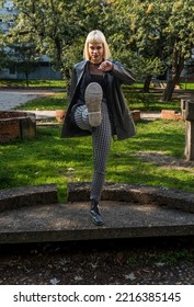 Young Beautiful Strong Independent Rebel Blonde Woman Punk Music And Style Fan Posing. Confident Punk-Rock Youth Culture Street Style Concept.	